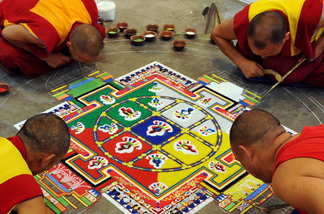 Tibetan Buddhist monks prepare a mandala - religious artwork made from coloured sand - during an exhibition at the Thank You India Festival in Bangalore on November 23, 2009. Tibetan exiles in India organised a three-day long festival the community's 50th year of living in exile in India, following the Tibetan spiritual leader the Dalai Lama's flight into exile from Tibet following an uprising in 1959. AFP PHOTO/Dibyangshu SARKAR (Photo credit should read DIBYANGSHU SARKAR/AFP/Getty Images)